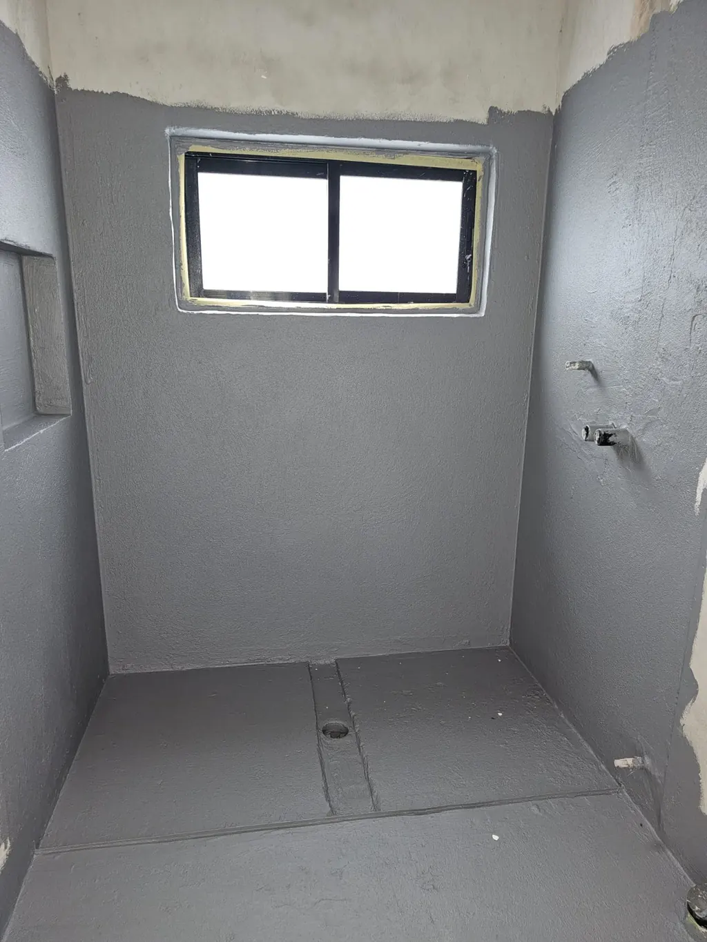 Milestone shower room in progress with wall preparation and floor tiling